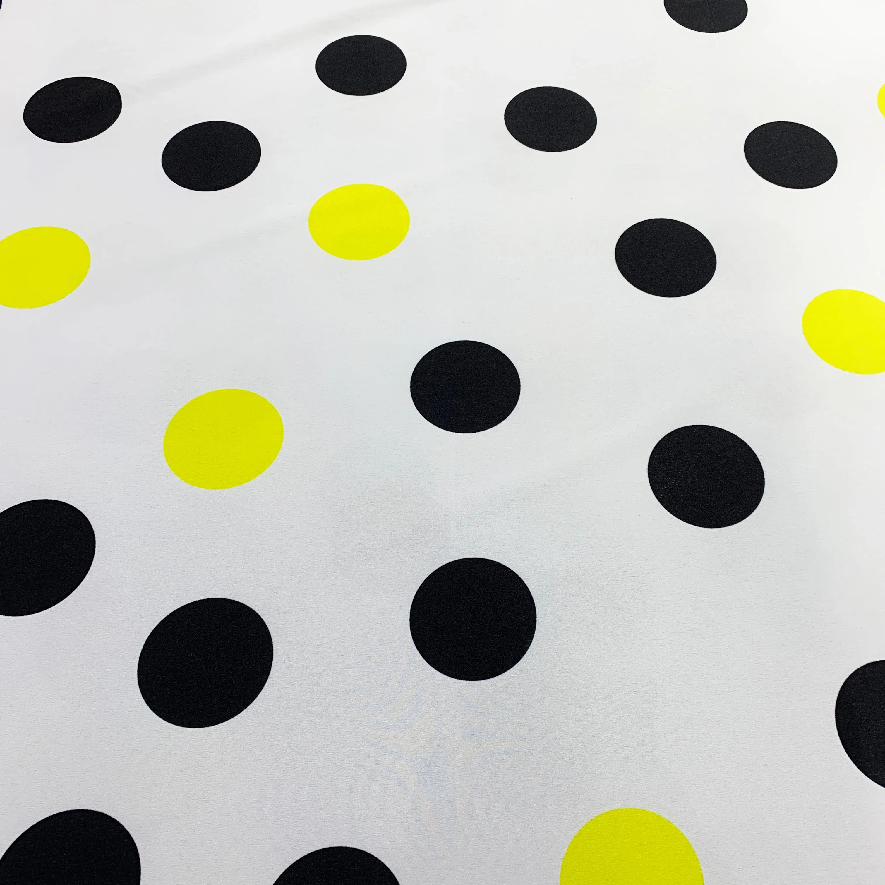 Black and Yellow Polka Dots on a White Background Printed Polyester Fabric